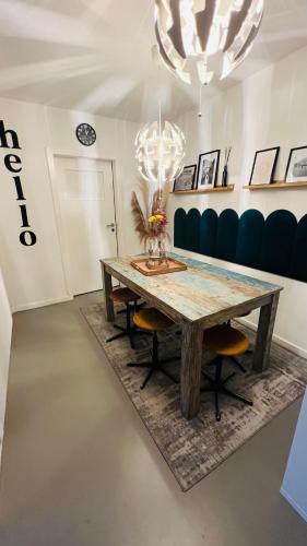 a dining room with a wooden table and a chandelier at Daheim in Essen in Essen