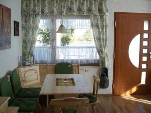 a living room with a table and a window at Fh Am Oberteich in Rammenau