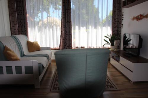 a living room with a couch and a large window at Fh Am Oberteich in Rammenau