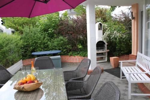 a table with a bowl of fruit on a patio at Ferienwohnung Vulkaneifel in Daun
