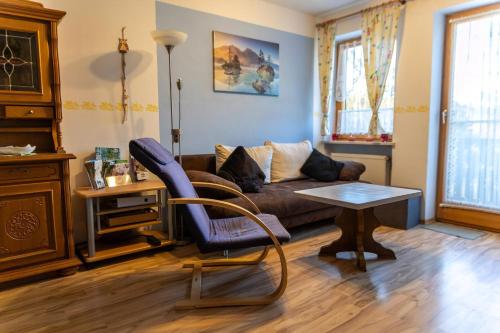 a living room with a couch and a table at Ferienwohnung Mit Zwei Schlafzimmern Und Balkon in Weißenstadt