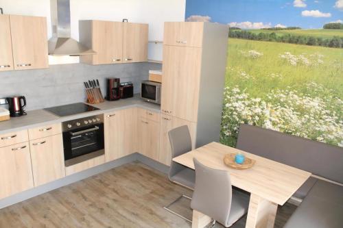 a kitchen with a table and a view of a field at Modernes Ferienhaus In Daun in Daun