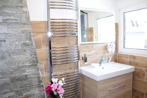 a bathroom with a sink and a stone wall at Modernes Ferienhaus In Daun in Daun