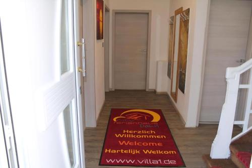 a welcome mat on the floor of a hallway at Modernes Ferienhaus In Daun in Daun