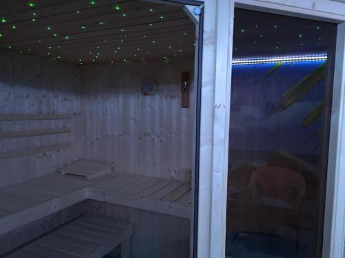 an empty sauna with a ceiling with green lights at Modernes Ferienhaus In Daun in Daun