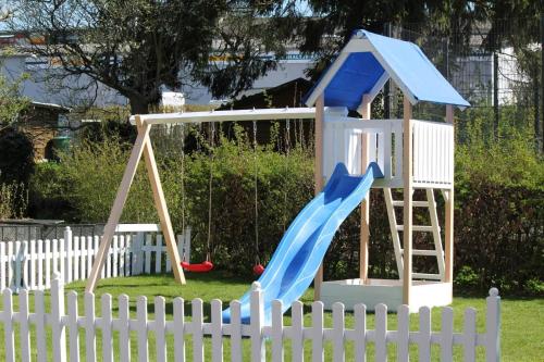 a playground with a slide and a slideintend at Modernes Ferienhaus In Daun in Daun
