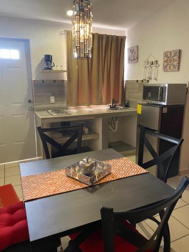 a kitchen with a table and a dining room at Sunrise in Los Cabos in Cabo San Lucas