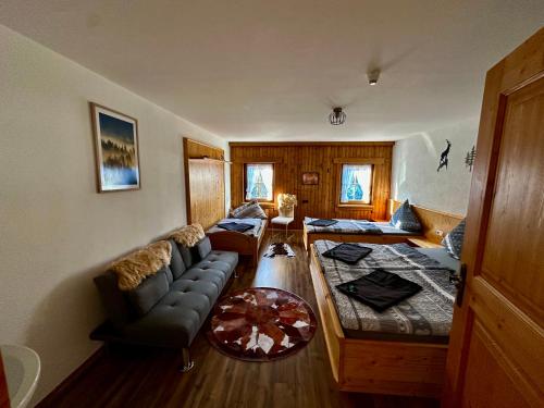 a living room with a couch and a table at Veitenhof im Kaisertal, nur nach 30 minütigem Spaziergang erreichbar, only after 30 minutes walk reachable in Ebbs