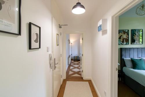 a hallway leading to a bedroom with a bed at Great offers on Long Stays!! LaLuNa Apartments in Gateshead