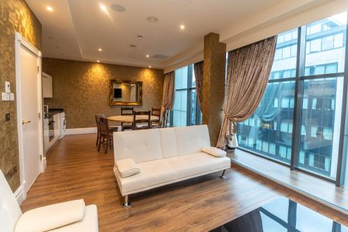 a living room with a white couch and a table at The Shankly Hotel in Liverpool