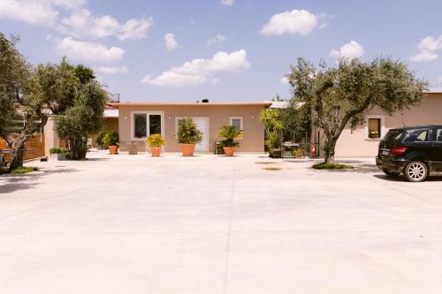 a car parked in a parking lot in front of a house at da Biagio B&B - Ristorante in San Severo