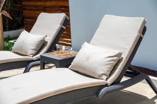 two chairs sitting on a patio with pillows at Villa Shepherd Zanzibar - LUXURY BEACH FRONT - KIWENGWA in Kumba Urembo