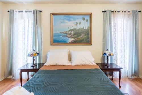 a bedroom with a bed with a painting on the wall at Spacious 4BR with Private Pool, Near Six Flags in San Antonio