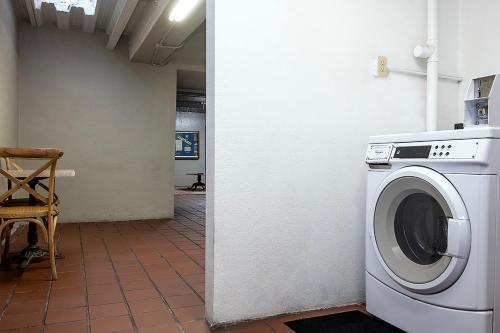 a washing machine sitting next to a wall at Gardner Hotel & Hostel in El Paso