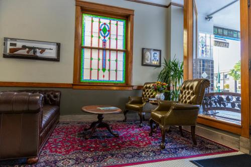 a waiting room with chairs and a stained glass window at Gardner Hotel & Hostel in El Paso