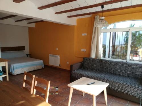 a living room with a couch and a bed at Allotjament Bogues in Lloret de Mar