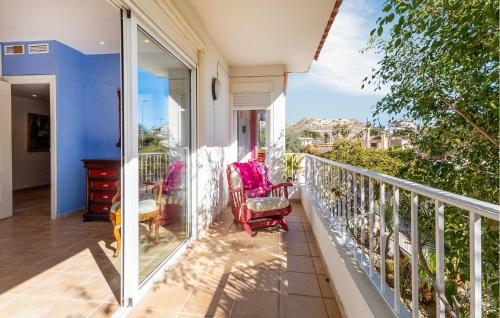 a balcony with two rocking chairs and a window at Stunning Home In El Campello in El Campello