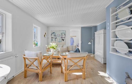 a dining room with a table and chairs at Beautiful Apartment In Tranekær in Tranekær