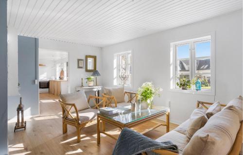 a living room with a couch and a table at Beautiful Apartment In Tranekær in Tranekær