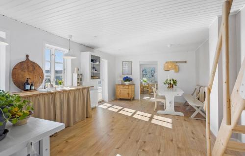 a kitchen and living room with white walls and wood floors at Beautiful Apartment In Tranekær in Tranekær