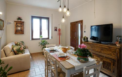 a living room with a table and a television at Pet Friendly Apartment in Chianciano Terme