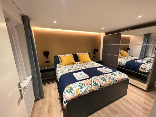 a hotel room with two beds and a mirror at B & B ANNAMIE in Vlissingen