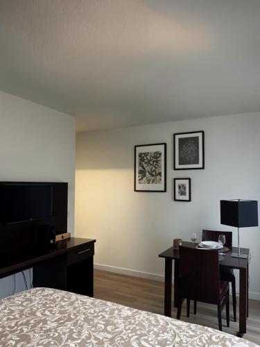 une chambre d'hôtel avec un bureau et un lit dans l'établissement Studio de 25m2 à proximité immédiate de Paris Expo, Porte de Versailles, à Malakoff