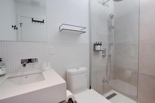 a bathroom with a shower and a toilet and a sink at Studio #9 - Self Check-In - Plateau - St-Denis in Montreal