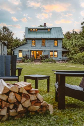 a house with a table and benches in front of it at The Bend in Phoenicia