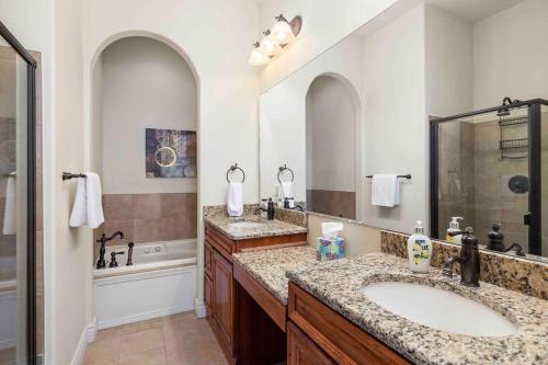 a bathroom with two sinks and a shower at Panoramic Penthouse at SDC in Branson