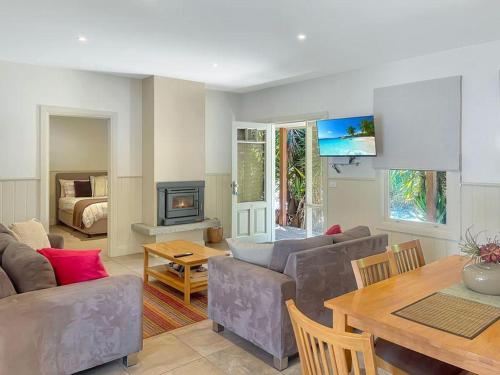 a living room with a couch and a table at River Rock Cottage Centrally located and Dog friendly in Jamieson