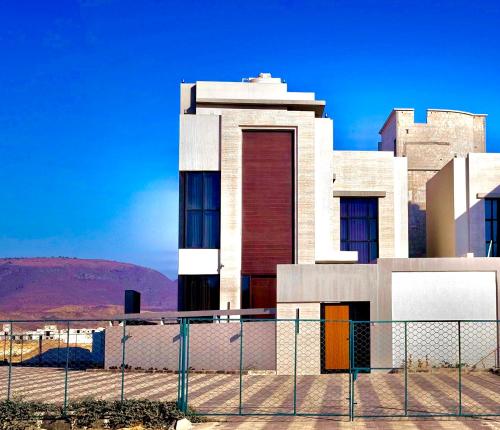 a building with a fence in front of it at Orchid vila in Salalah