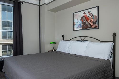 a bedroom with a bed and a large window at Gardner Hotel & Hostel in El Paso