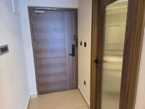 a wooden door in a room with a hallway at MoonBasa Boutique Hotel and Spa Infopark , Kakkanad in Cochin
