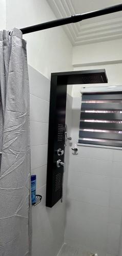 a bathroom with a shower with a towel at Pebbles Nest in Kwabenya