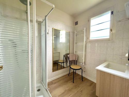 a bathroom with a shower and a table and a sink at Villa Saint Antoine, vue mer à 60m de la plage in Réville