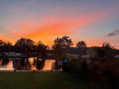 a sunset over a body of water with the sky at Harrys lounge in Whitby