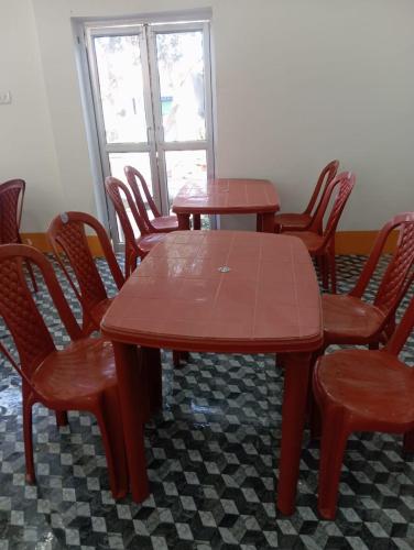 a wooden table and chairs in a room at TabTrips Laxmi Resort in Bāghmundi
