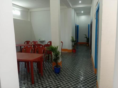a room with a table and chairs and a table and chairs at TabTrips Laxmi Resort in Bāghmundi