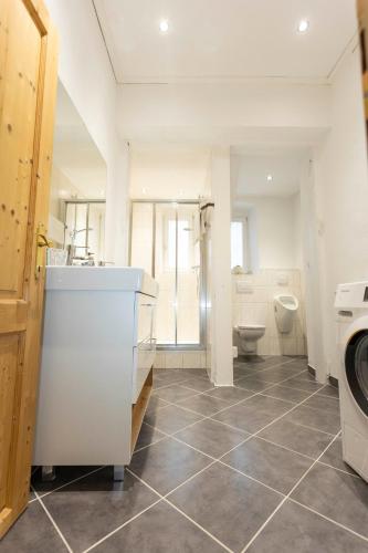 a bathroom with a washing machine and a toilet at Seebühnenblick in Seeham