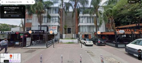 a city street with cars parked in front of buildings at Minimalist Verde Chapu in Guadalajara