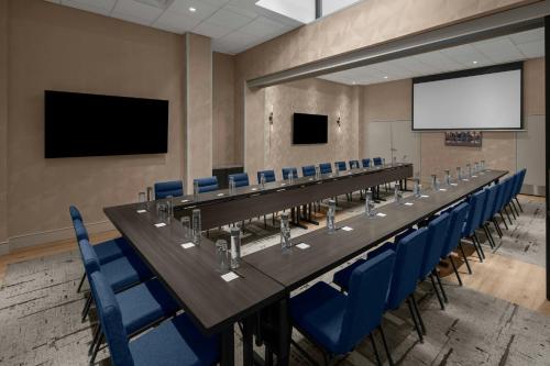 a long conference room with a long table and blue chairs at Courtyard by Marriott New York World Trade Center Area in New York