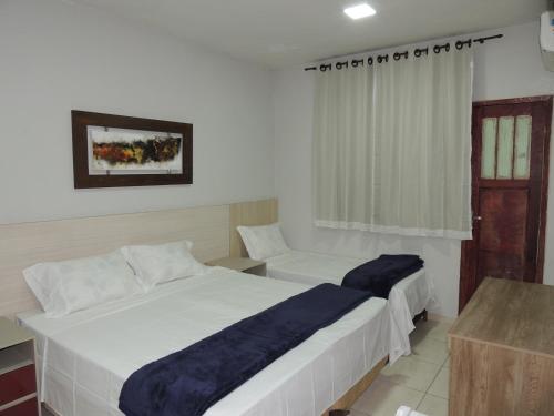 Giường trong phòng chung tại Hotel Continental - Próximo ao Mercado Central, Mercado Novo e a Rodoviária