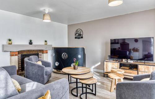 a living room with a couch and chairs and a fireplace at Nice Home In Saint-Samson-De-La-Roq in Saint-Samson-de-la-Roque