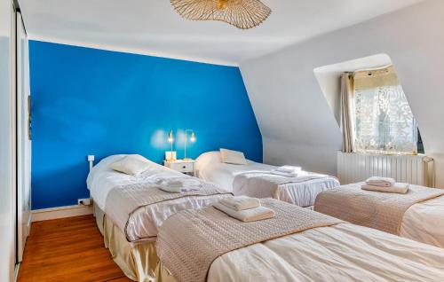 three beds in a room with blue walls at Nice Home In Saint-Samson-De-La-Roq in Saint-Samson-de-la-Roque