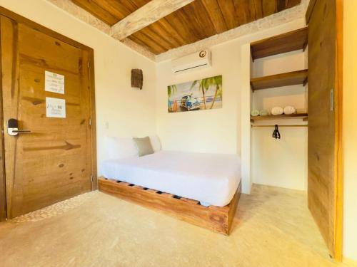 a bedroom with a bed and a wooden door at Soul Dream Bonita in Las Terrenas