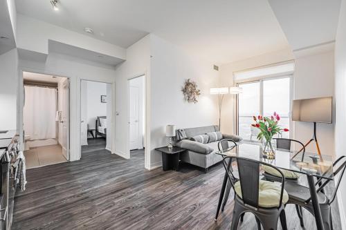 a living room with a table and a couch at 2BR Condo close to Eaton Center in Toronto