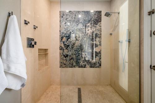 a bathroom with a shower with a painting on the wall at Northridge Mesa in Mesa