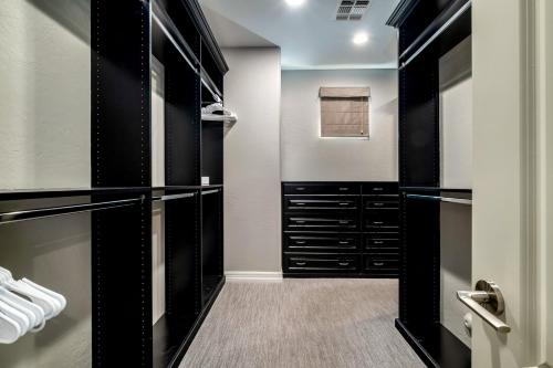 a walk in closet with black cabinets and drawers at Northridge Mesa in Mesa