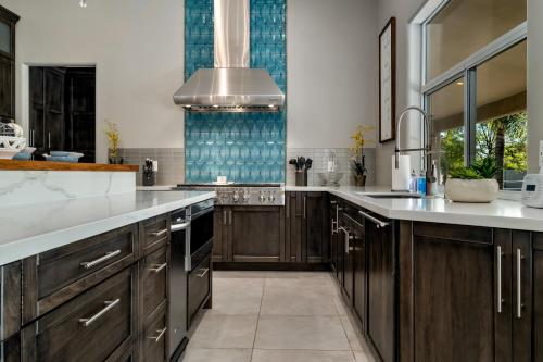 a large kitchen with wooden cabinets and a sink at Northridge Mesa in Mesa